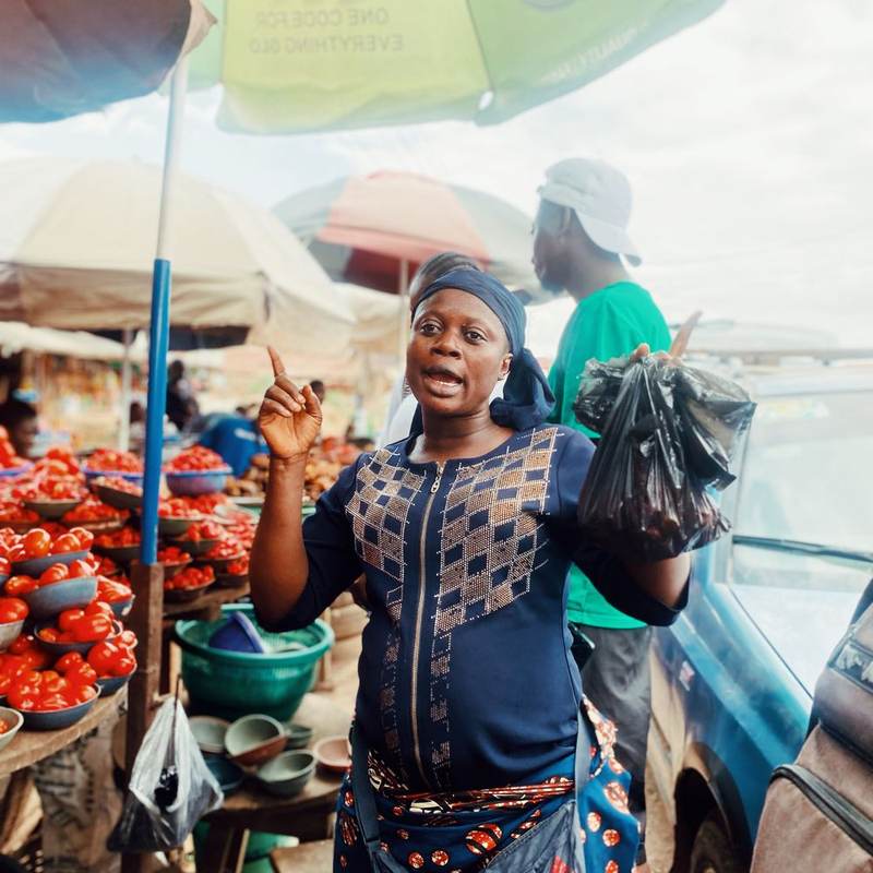 A market trader at a vegetable stall